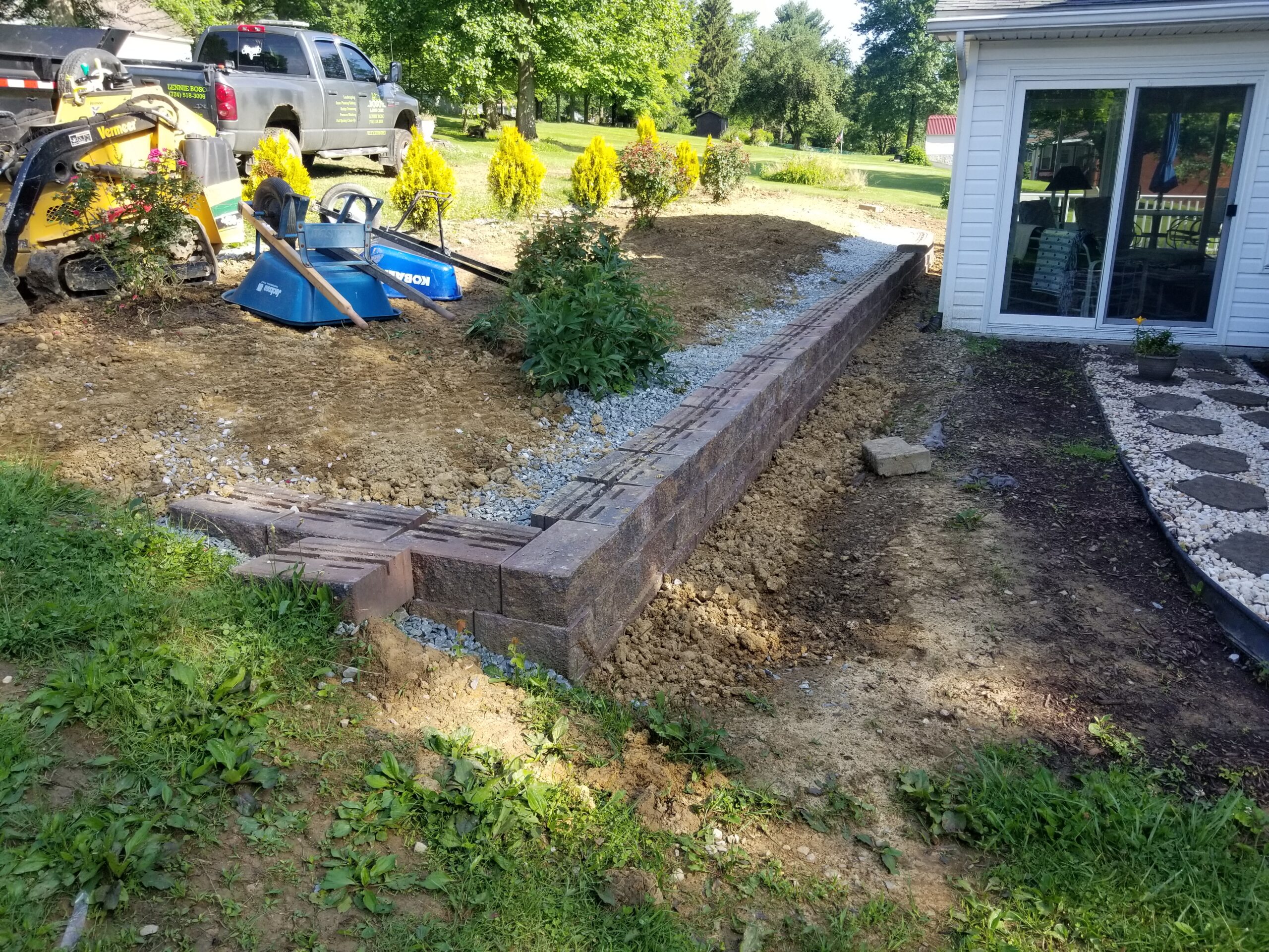 Boso's crew building a retaining wall and landscaping a Mon Valley home