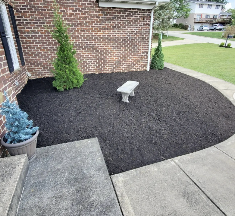 Freshly mulched landscaping bed by Boso's Lawn Care